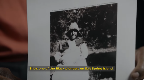 A photograph Sylvia Stark, one of the Black pioneers on Salt Spring Island. She is wearing a white dress and sitting outside. 