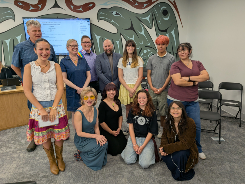Students and members of the Board of Education pose for a photograph in the Board Room. 