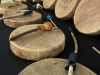 Hide drums and handmade rattles rest on a table. 