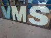 A window with large blue letters that read VMS. 