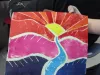 A student displays a vibrant red, purple and pink print from a class with senior citizens. 